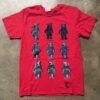 Red tee hand printed with nine blue and black raccoons standing in rows