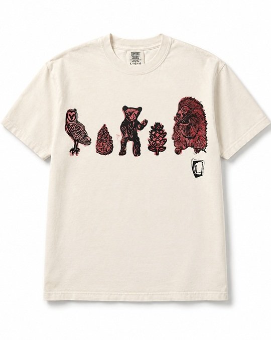 Cream tee hand printed with an owl, a bear, a porcupine and two pinecones in black and pink