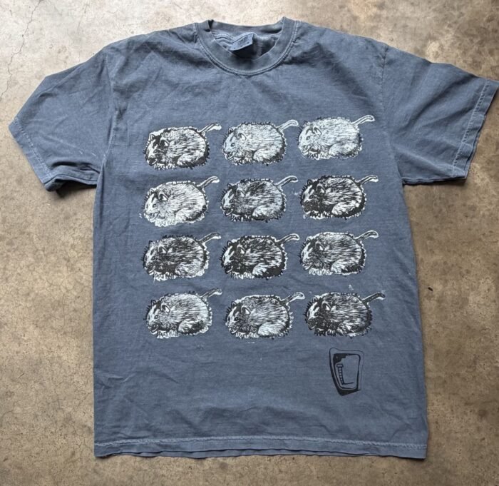 Blue-grey tee hand printed with twelve curled opossums in rows